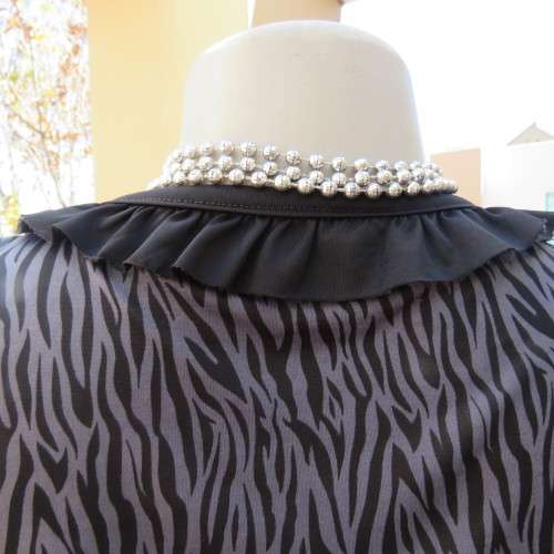 Sexy little animal print top. Empire front. V-neckline.Size 32/8. By Insync Formal. New condition.