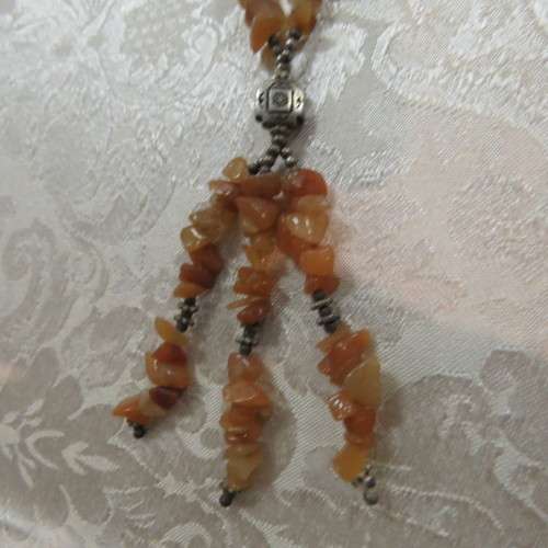 Beautiful genuine stone necklace made up of small brick colour stones. New.