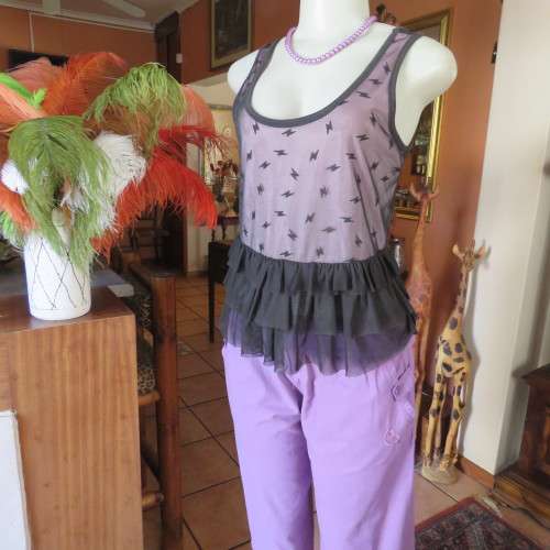 Cute little black netting top. Pale lilac underlay on front. Scooped neckline. Size 34/10. as new.