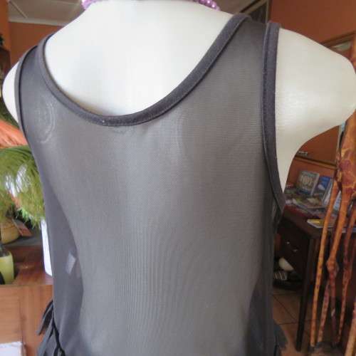Cute little black netting top. Pale lilac underlay on front. Scooped neckline. Size 34/10. as new.