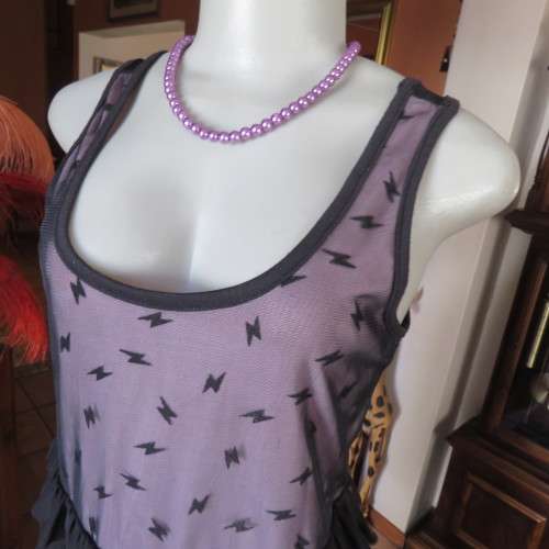 Cute little black netting top. Pale lilac underlay on front. Scooped neckline. Size 34/10. as new.