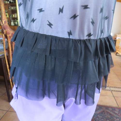 Cute little black netting top. Pale lilac underlay on front. Scooped neckline. Size 34/10. as new.