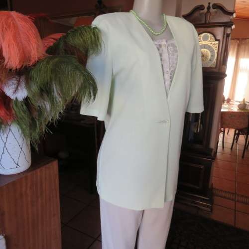 Light mint green short sleeve jacket/cover-up low V-front. Size 34/10 by SOFT BLOUSE. New condition.