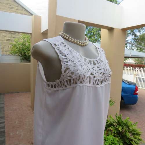 Stunning DELTON white sleeveless top. Amazing see-through ribbon decoration. Size 36/12. As new.