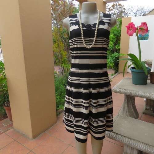 Beautiful black and cream sleeveless dress Size 34 as on doll Can fit size 36 Good condition