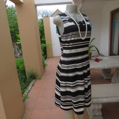 Beautiful black and cream sleeveless dress Size 34 as on doll Can fit size 36 Good condition
