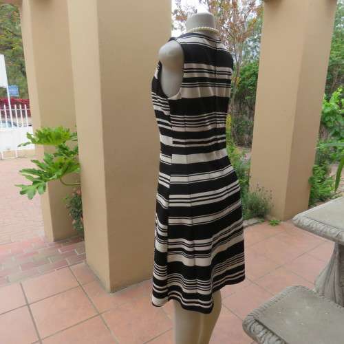 Beautiful black and cream sleeveless dress Size 34 as on doll Can fit size 36 Good condition
