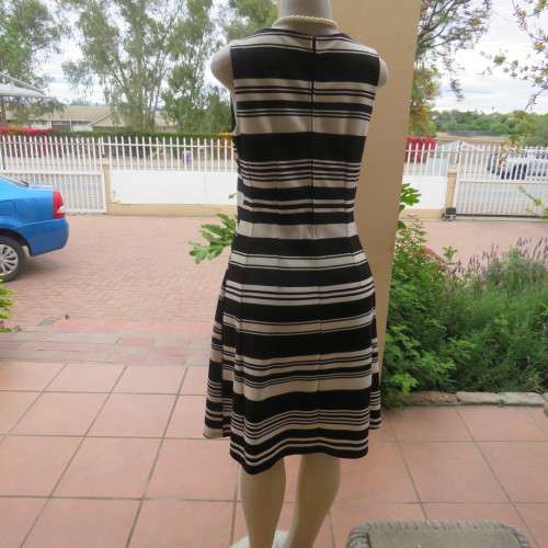Beautiful black and cream sleeveless dress Size 34 as on doll Can fit size 36 Good condition