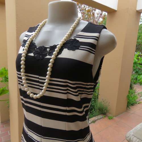 Beautiful black and cream sleeveless dress Size 34 as on doll Can fit size 36 Good condition