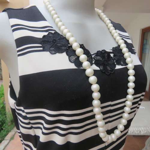 Beautiful black and cream sleeveless dress Size 34 as on doll Can fit size 36 Good condition