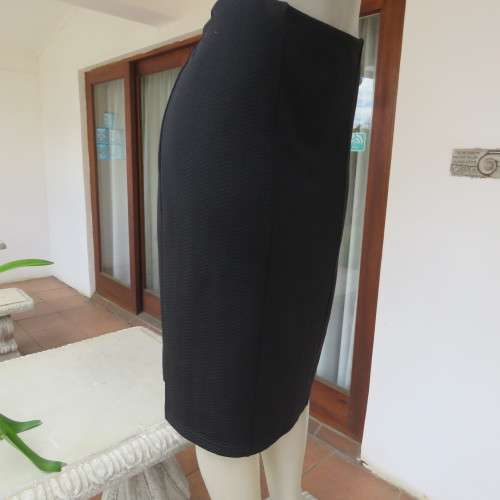 Black bodycon stretch polyester low-calf length skirt. Size 42/18. By `Donatella`. New condition.