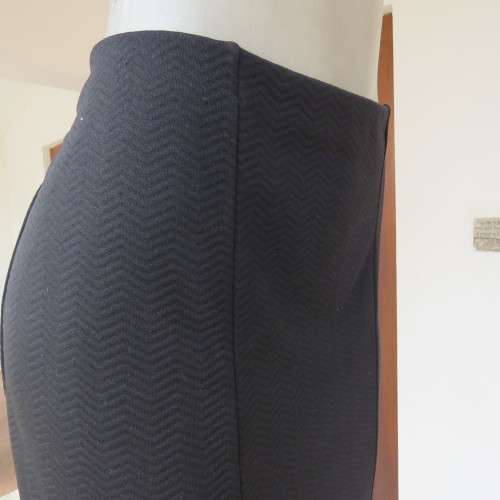 Black bodycon stretch polyester low-calf length skirt. Size 42/18. By `Donatella`. New condition.