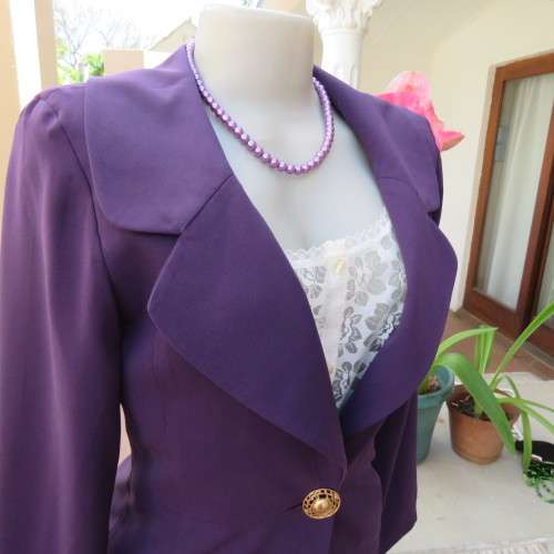 Elegant dark purple long sleeve jacket. Fully lined. By `Truworths`. In size 32/8. New condition.