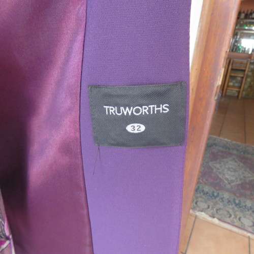 Elegant dark purple long sleeve jacket. Fully lined. By `Truworths`. In size 32/8. New condition.