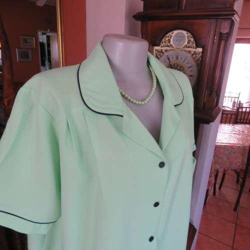 Lime green short sleeve top. Round collar. Size 46 to 48. By . Good condition.