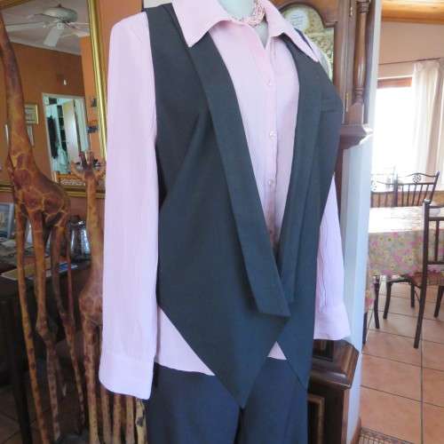 Ladies black tuxedo waistcoat. Tiny dummy front pocket. By `Legit`. In size 40/16. New condition.