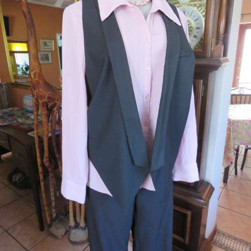 Ladies black tuxedo waistcoat. Tiny dummy front pocket. By `Legit`. In size 40/16. New condition.
