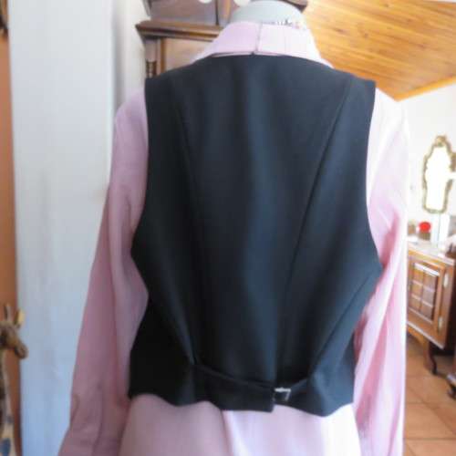 Ladies black tuxedo waistcoat. Tiny dummy front pocket. By `Legit`. In size 40/16. New condition.