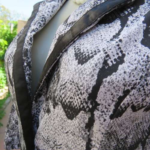 Chic black and white animal print long sleeve jacket. Open collar. Size 30/6. By `Massumi`. As new.