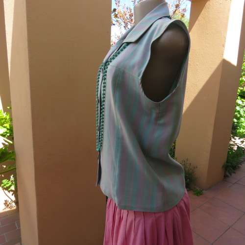 Boutique made sleeveless top in soft blue/pink check pattern. Size 38. As new. Button down front
