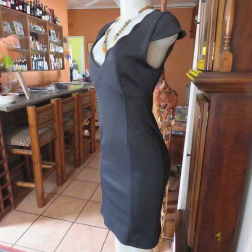 Fabulous sleek black dress with wide scalloped neckline. By `Massumi`. Size 34/10. Never used. New.