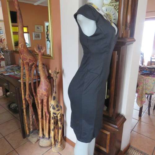 Fabulous sleek black dress with wide scalloped neckline. By `Massumi`. Size 34/10. Never used. New.
