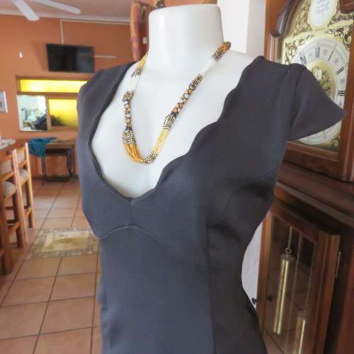 Fabulous sleek black dress with wide scalloped neckline. By `Massumi`. Size 34/10. Never used. New.