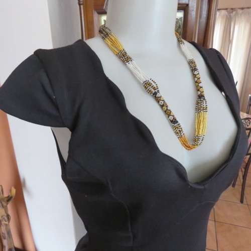 Fabulous sleek black dress with wide scalloped neckline. By `Massumi`. Size 34/10. Never used. New.
