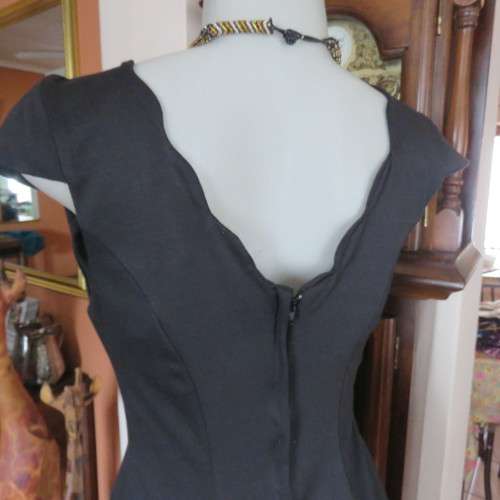 Fabulous sleek black dress with wide scalloped neckline. By `Massumi`. Size 34/10. Never used. New.