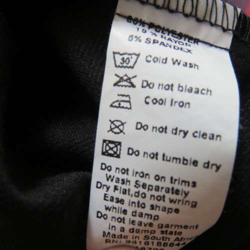 Fabulous sleek black dress with wide scalloped neckline. By `Massumi`. Size 34/10. Never used. New.