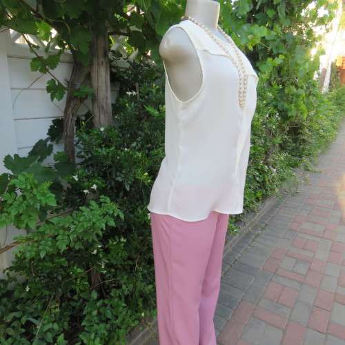 Unique cream sleeveless top with button down back. Size 34/10. By `Oakridge`. New condition.