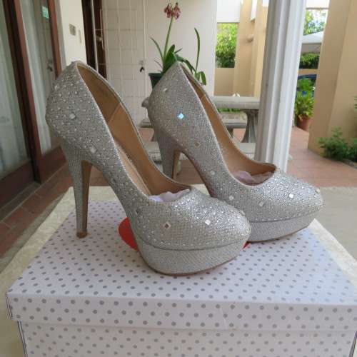 Pair as new silver pumps in size 2 with high heels. By `Miss Milano`. Used once. Still in box.