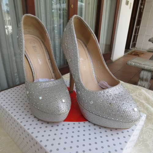 Pair as new silver pumps in size 2 with high heels. By `Miss Milano`. Used once. Still in box.