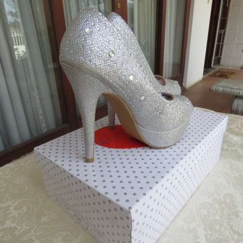 Pair as new silver pumps in size 2 with high heels. By `Miss Milano`. Used once. Still in box.