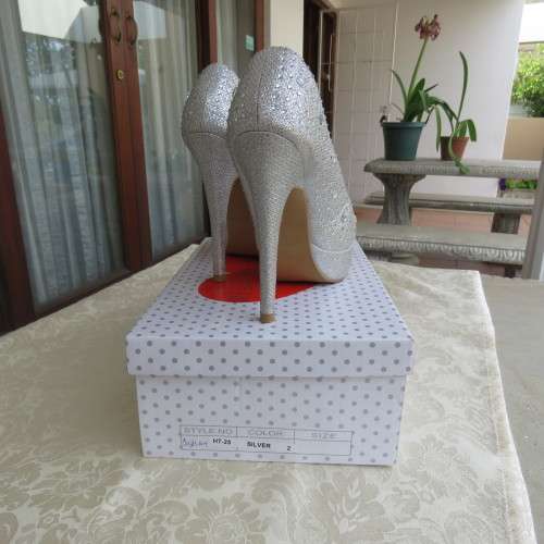 Pair as new silver pumps in size 2 with high heels. By `Miss Milano`. Used once. Still in box.