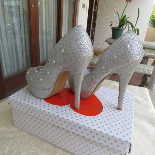Pair as new silver pumps in size 2 with high heels. By `Miss Milano`. Used once. Still in box.