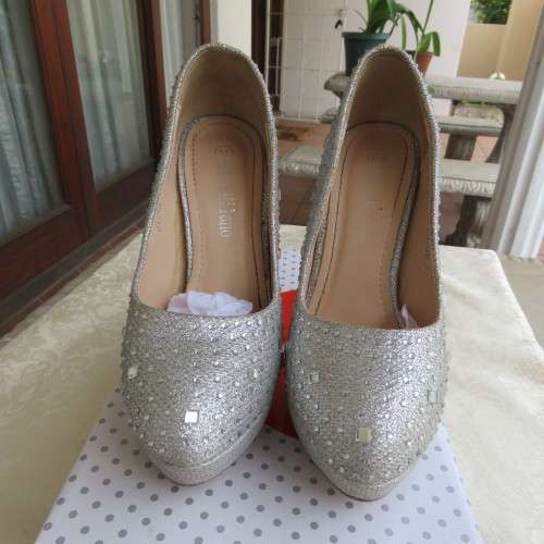 Pair as new silver pumps in size 2 with high heels. By `Miss Milano`. Used once. Still in box.