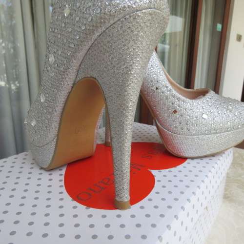 Pair as new silver pumps in size 2 with high heels. By `Miss Milano`. Used once. Still in box.