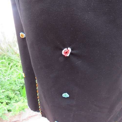 Ethnic style black apron. Bands to tie at back. With bead decoration edging. New condition.