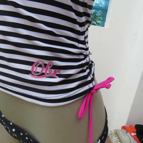Black and white striped bathing suite top in size 30/6 by `OBR`. Build in bra. New condition.