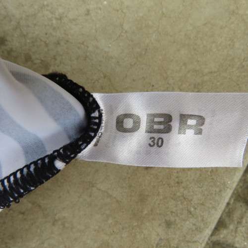 Black and white striped bathing suite top in size 30/6 by `OBR`. Build in bra. New condition.