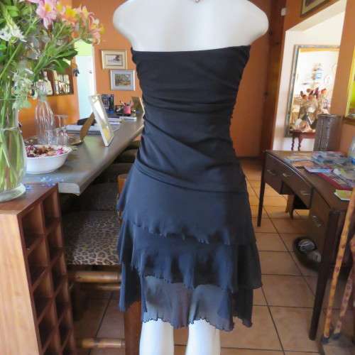 Little black dress with frilled bottom and ruched strapless top. Size 34/10 By `Jin Taiyang`. As new