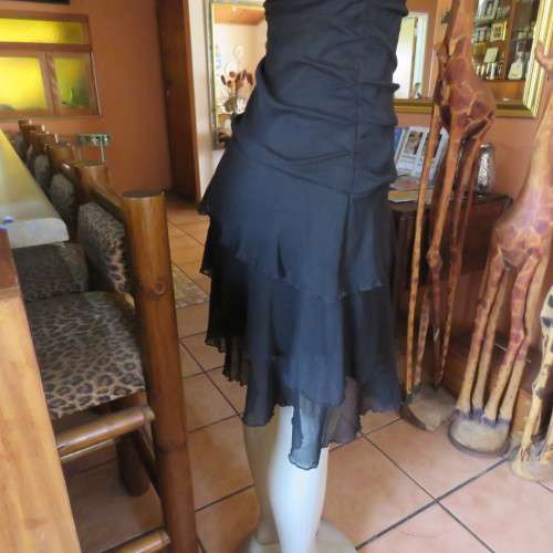 Little black dress with frilled bottom and ruched strapless top. Size 34/10 By `Jin Taiyang`. As new