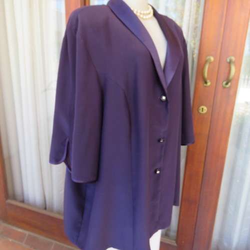 Top of the line very dark purple short sleeve top/jacket by `Penny C` in size 52/28. New condition.
