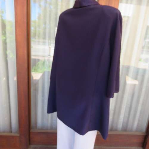 Top of the line very dark purple short sleeve top/jacket by `Penny C` in size 52/28. New condition.
