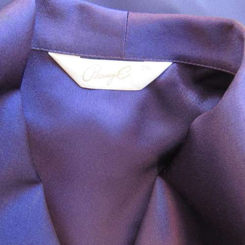 Top of the line very dark purple short sleeve top/jacket by `Penny C` in size 52/28. New condition.