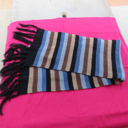 As new. Men`s knitted scarf in brown, cream, grey, blue and black stripes. Size 160cm x 23cm.