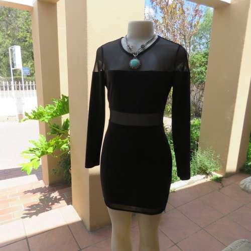 Cute little black bodycon dress with long sleeves in mini length. Size 32/8 by RT. New condition