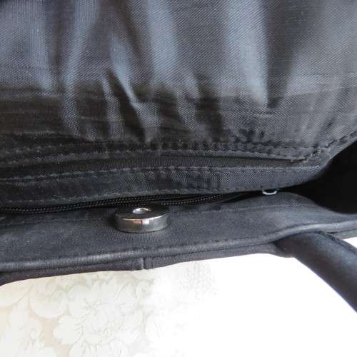 Small black bucket style handbag in shiny blocked vinyl .Size 18 x 16cm. As new