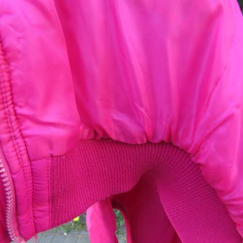 Warm magenta pink padded zip up waistcoat in size 36/12. Front pockets. Knitted ribbings.